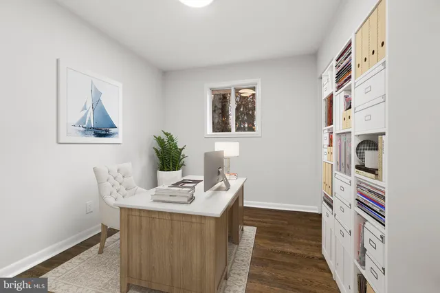 a view of a workspace with furniture and hallway