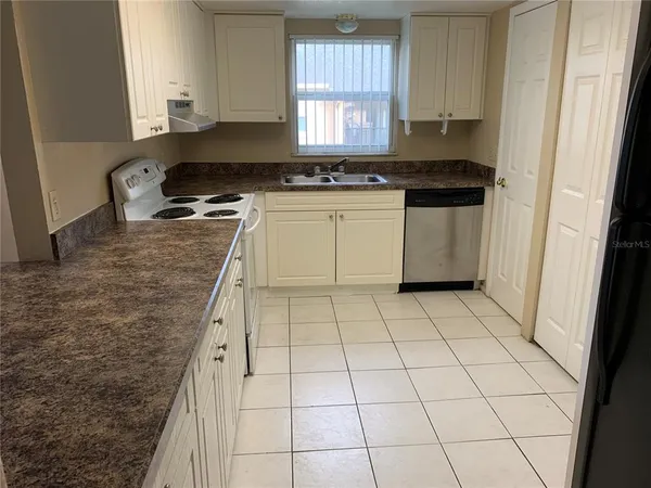 a kitchen with a stove a sink and a refrigerator