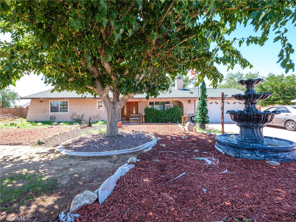 12638 Sholic Road Apple Valley, CA 92308 - Photo 1 of 1 a view of a house with garden and plants