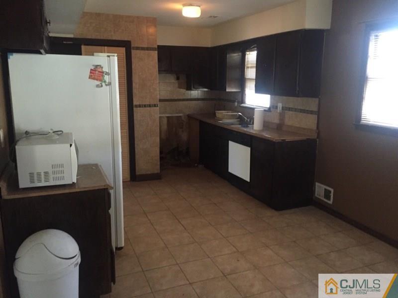 29 Roxy Avenue Edison, NJ 08820 - Photo 5 of 11 a kitchen with a sink cabinets and appliances
