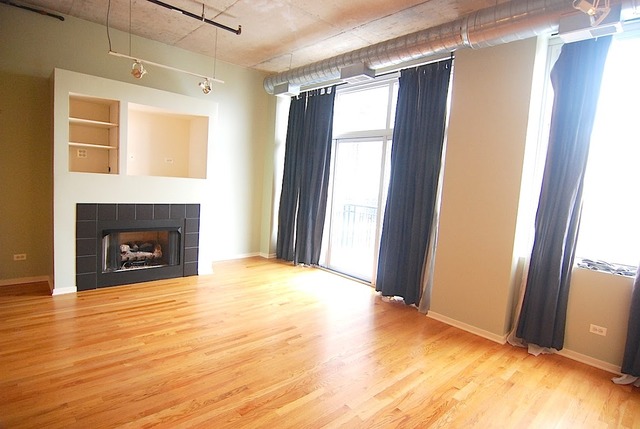1000 West Adams Street, Unit 719 Chicago, IL 60607 - Photo 3 of 9 a view of livingroom with fireplace and window