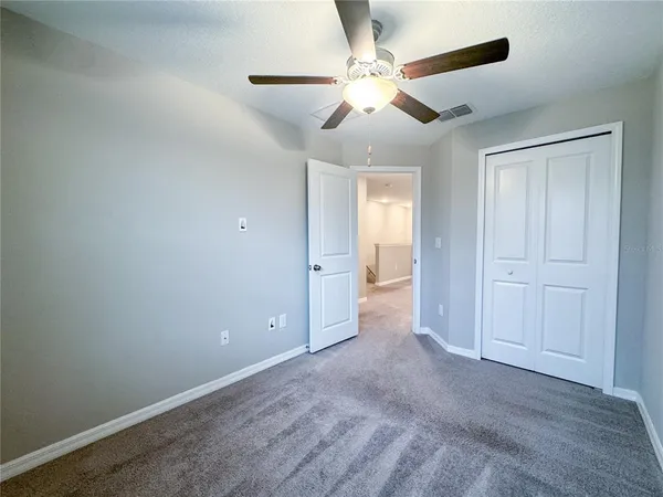 an empty room with fan and a ceiling fan