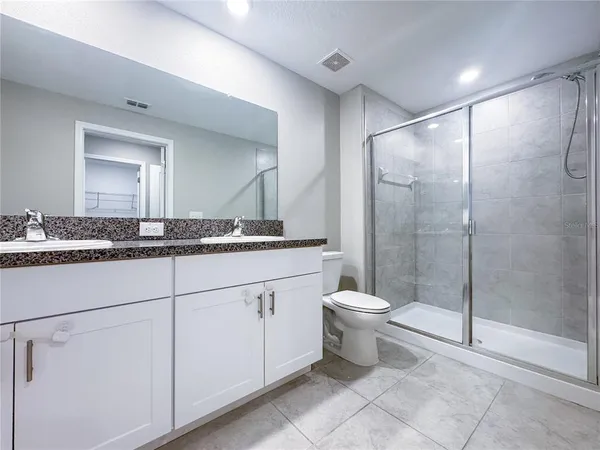 a bathroom with a toilet a sink and a mirror