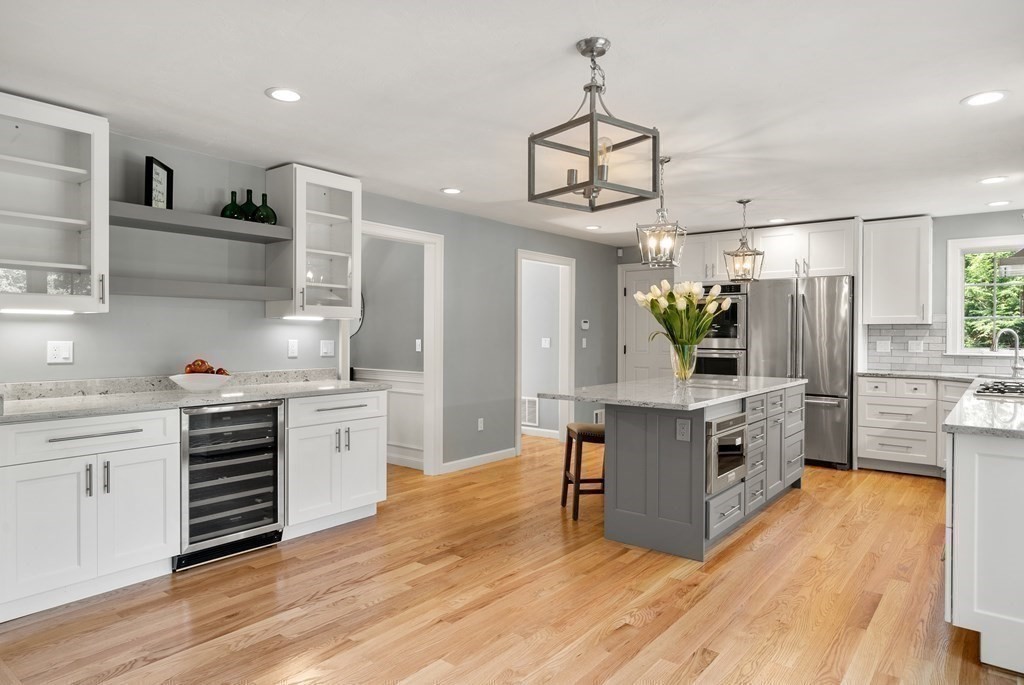 1 Barnbridge Circle Framingham, MA 01701 - Photo 12 of 42 a kitchen with stainless steel appliances a stove top oven and a wooden floor