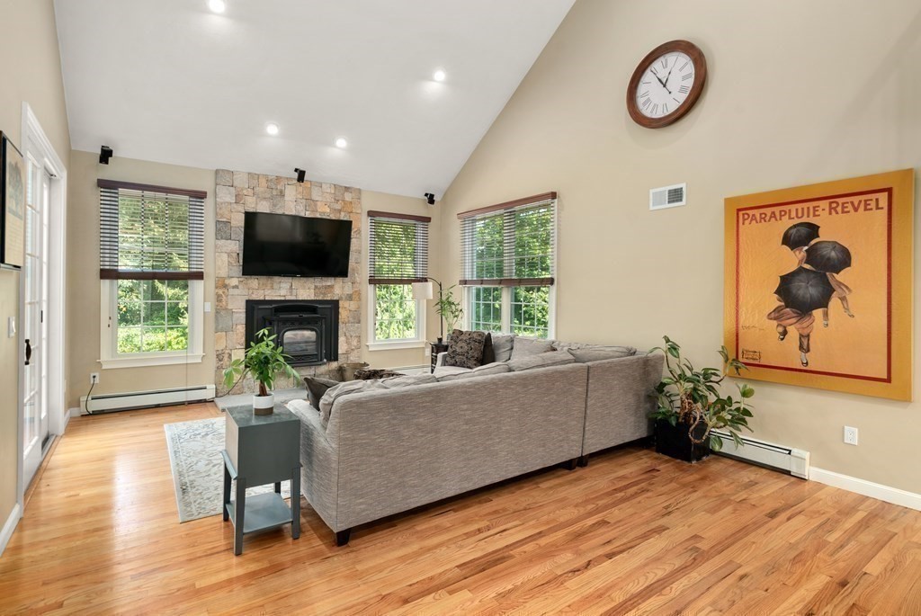 1 Barnbridge Circle Framingham, MA 01701 - Photo 13 of 42 a living room with furniture a fireplace and a flat screen tv