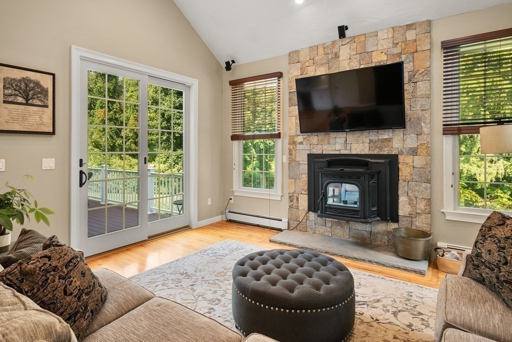 1 Barnbridge Circle Framingham, MA 01701 - Photo 15 of 42 a living room with a fireplace and a flat screen tv