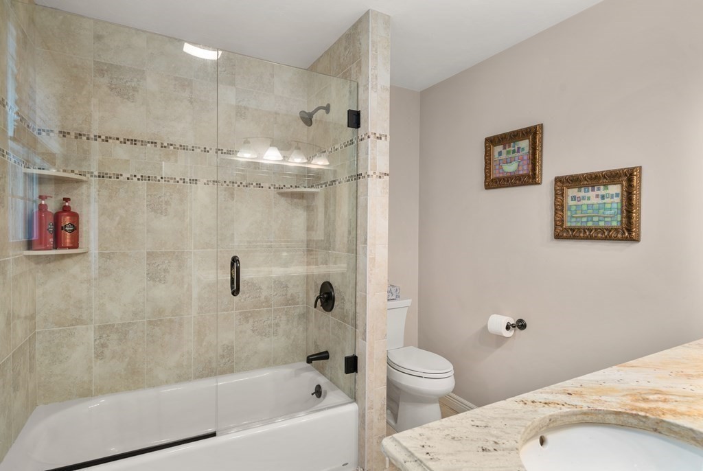 1 Barnbridge Circle Framingham, MA 01701 - Photo 25 of 42 a bathroom with a granite countertop sink a toilet and shower