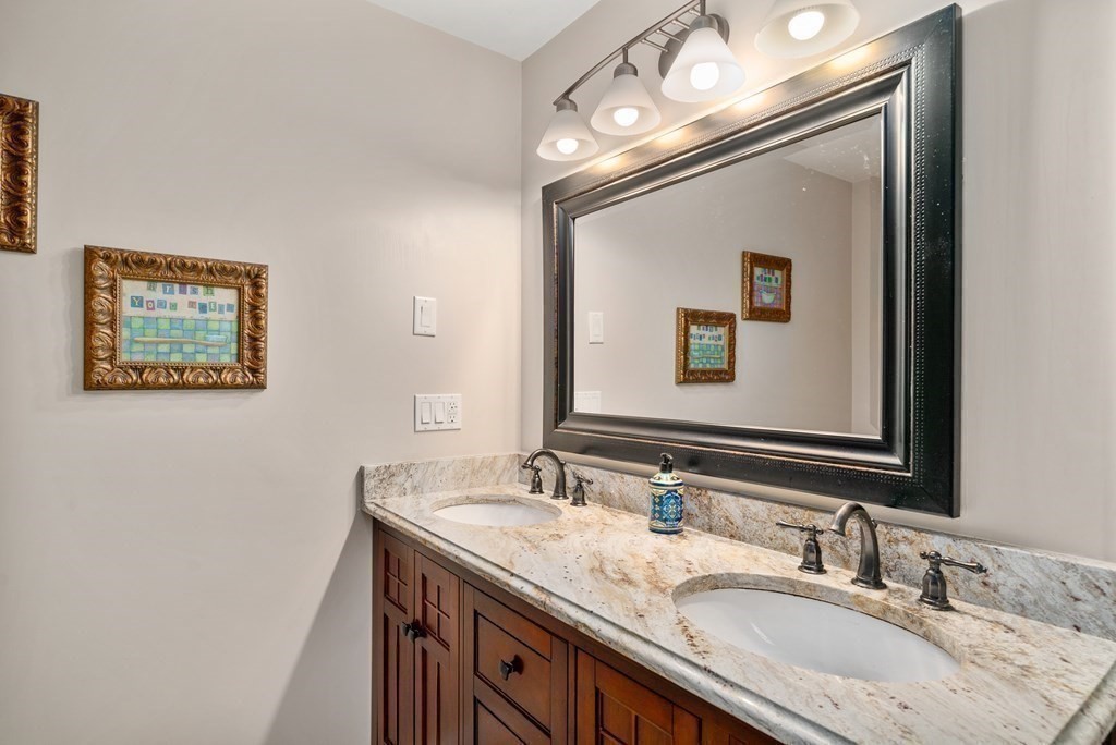 1 Barnbridge Circle Framingham, MA 01701 - Photo 26 of 42 a bathroom with a granite countertop sink a large mirror and a
