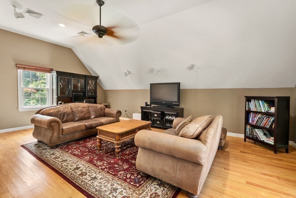 1 Barnbridge Circle Framingham, MA 01701 - Photo 27 of 42 a living room with furniture a flat screen tv and a rug