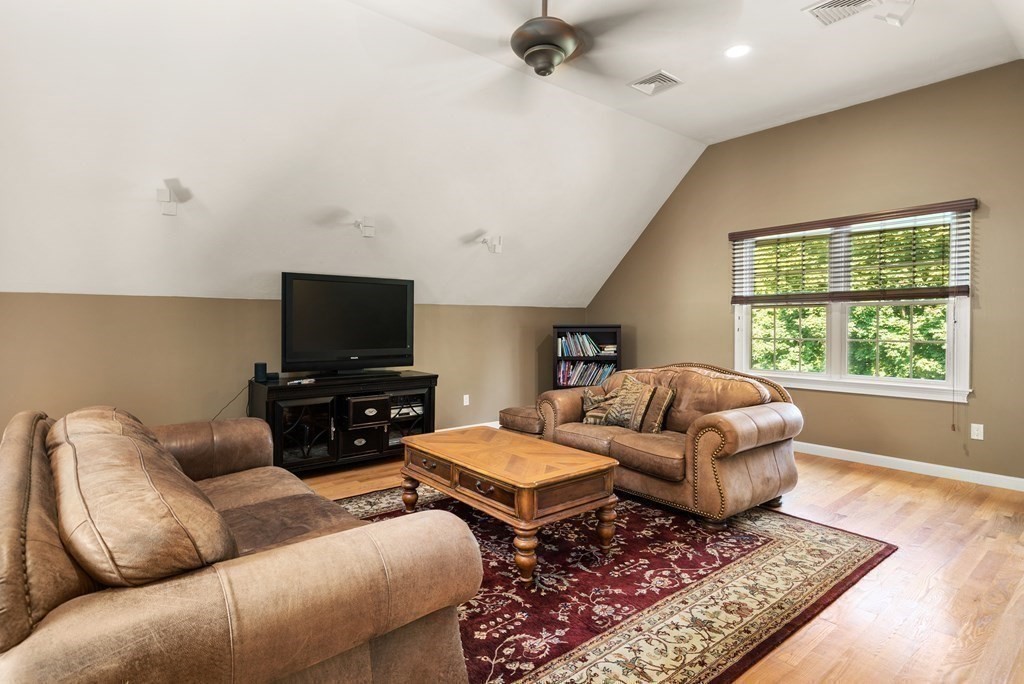 1 Barnbridge Circle Framingham, MA 01701 - Photo 28 of 42 a living room with furniture and a flat screen tv