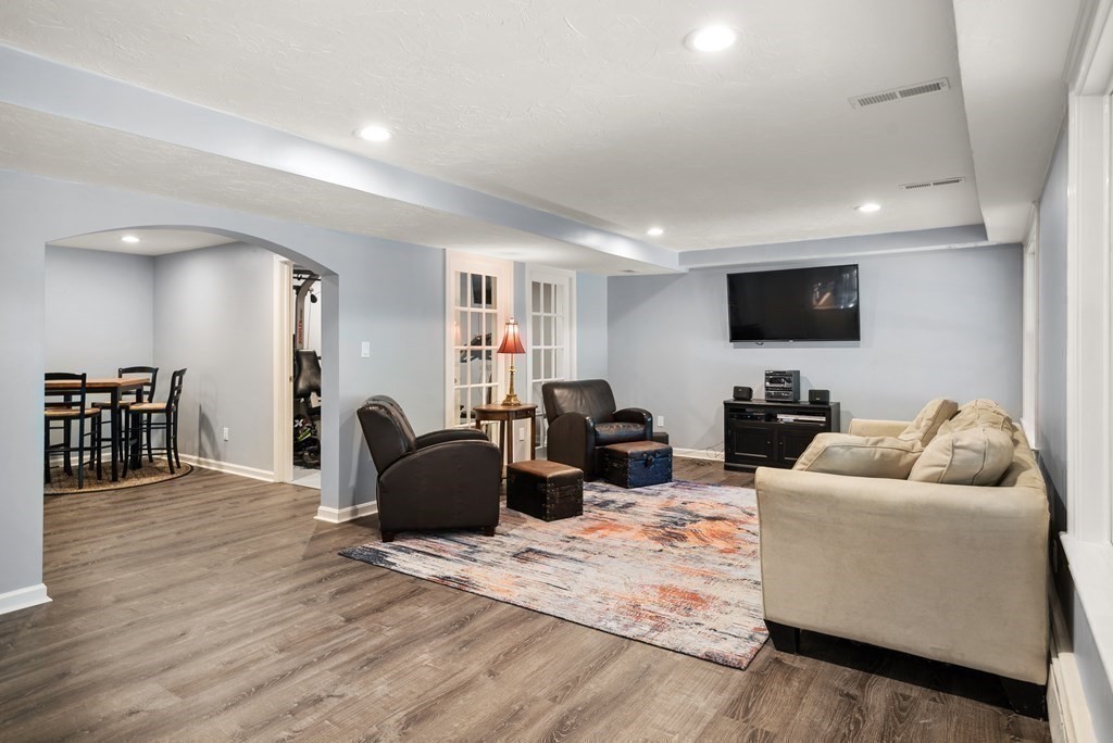 1 Barnbridge Circle Framingham, MA 01701 - Photo 31 of 42 a living room with furniture and a flat screen tv