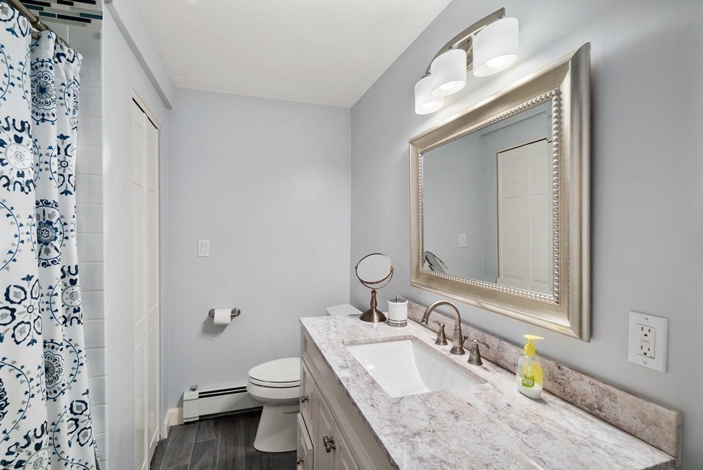 1 Barnbridge Circle Framingham, MA 01701 - Photo 34 of 42 a bathroom with a granite countertop sink toilet and mirror