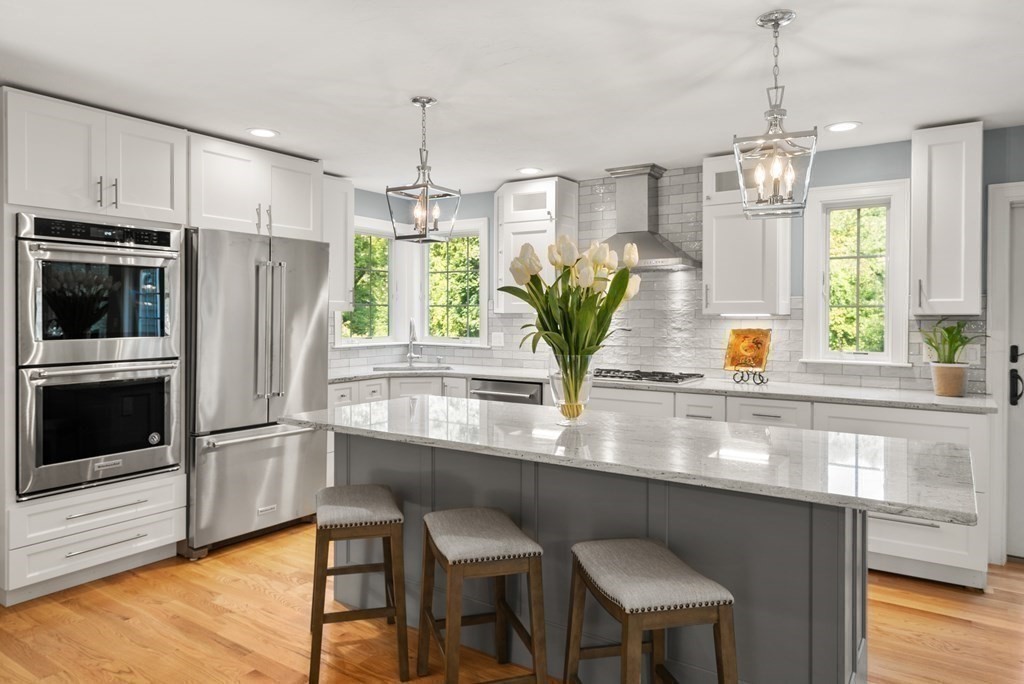 1 Barnbridge Circle Framingham, MA 01701 - Photo 8 of 42 a kitchen with stainless steel appliances a dining table chairs and chandelier