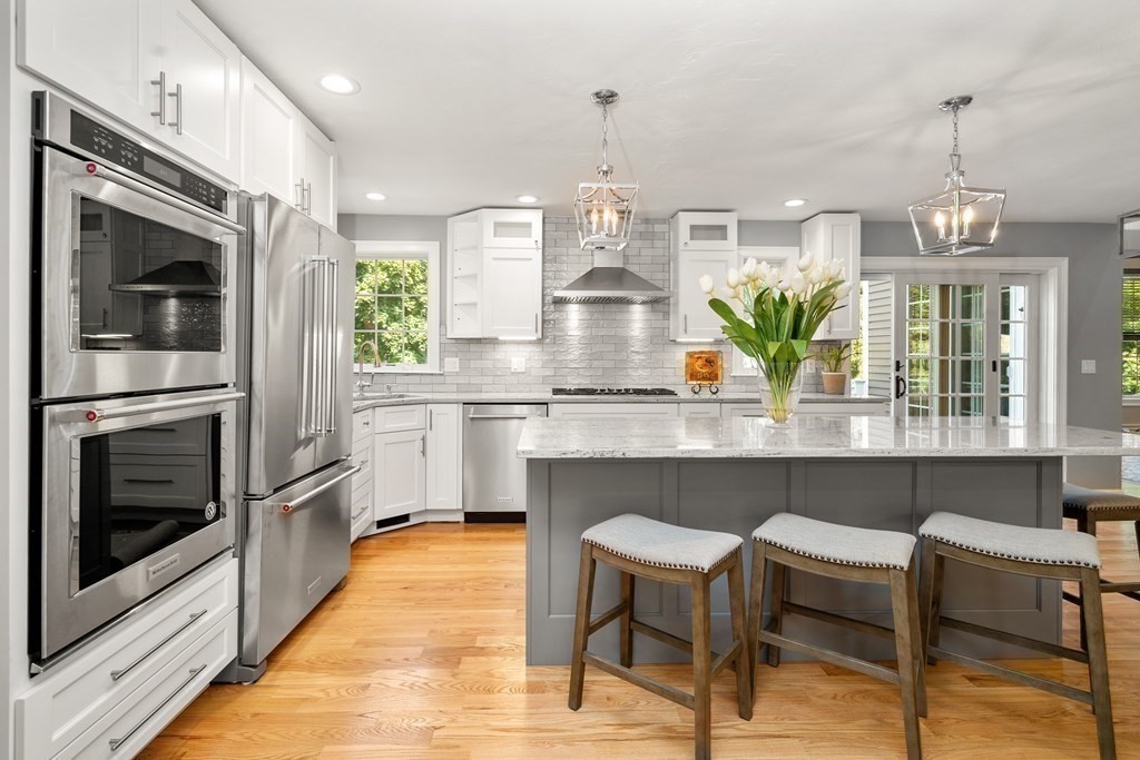 1 Barnbridge Circle Framingham, MA 01701 - Photo 9 of 42 a kitchen with stainless steel appliances granite countertop table chairs and granite counter tops