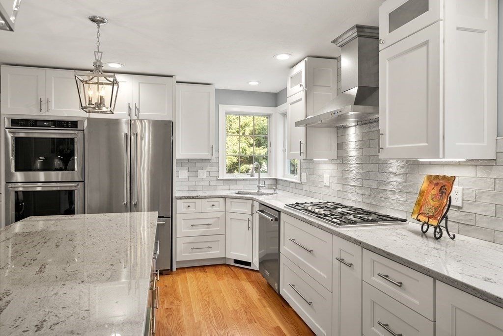 1 Barnbridge Circle Framingham, MA 01701 - Photo 10 of 42 a kitchen with stainless steel appliances granite countertop a stove refrigerator sink and cabinets