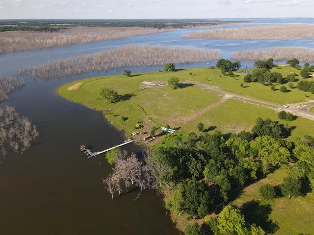 a view of a lake with couches chairs