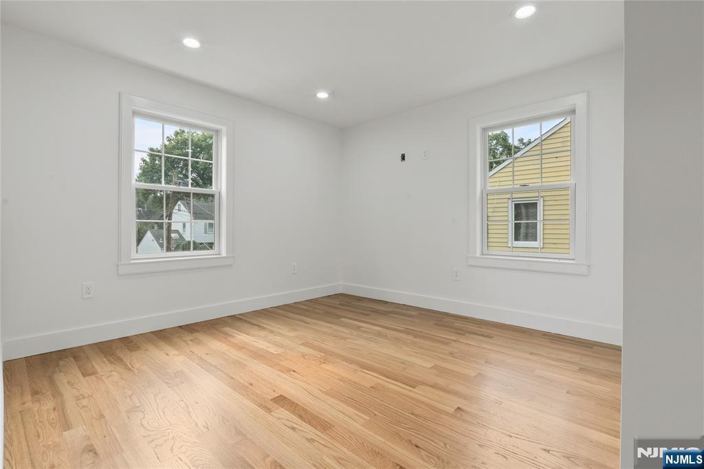 24 Ryder Road Fair Lawn, NJ 07410 - Photo 13 of 19 a view of an empty room with a window and wooden floor