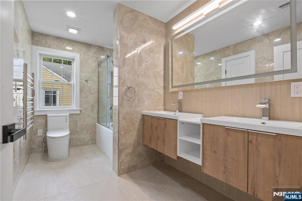 24 Ryder Road Fair Lawn, NJ 07410 - Photo 14 of 19 a bathroom with a sink a toilet and shower