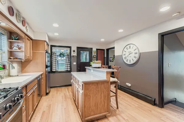 a large kitchen with a large window and a clock on the wall