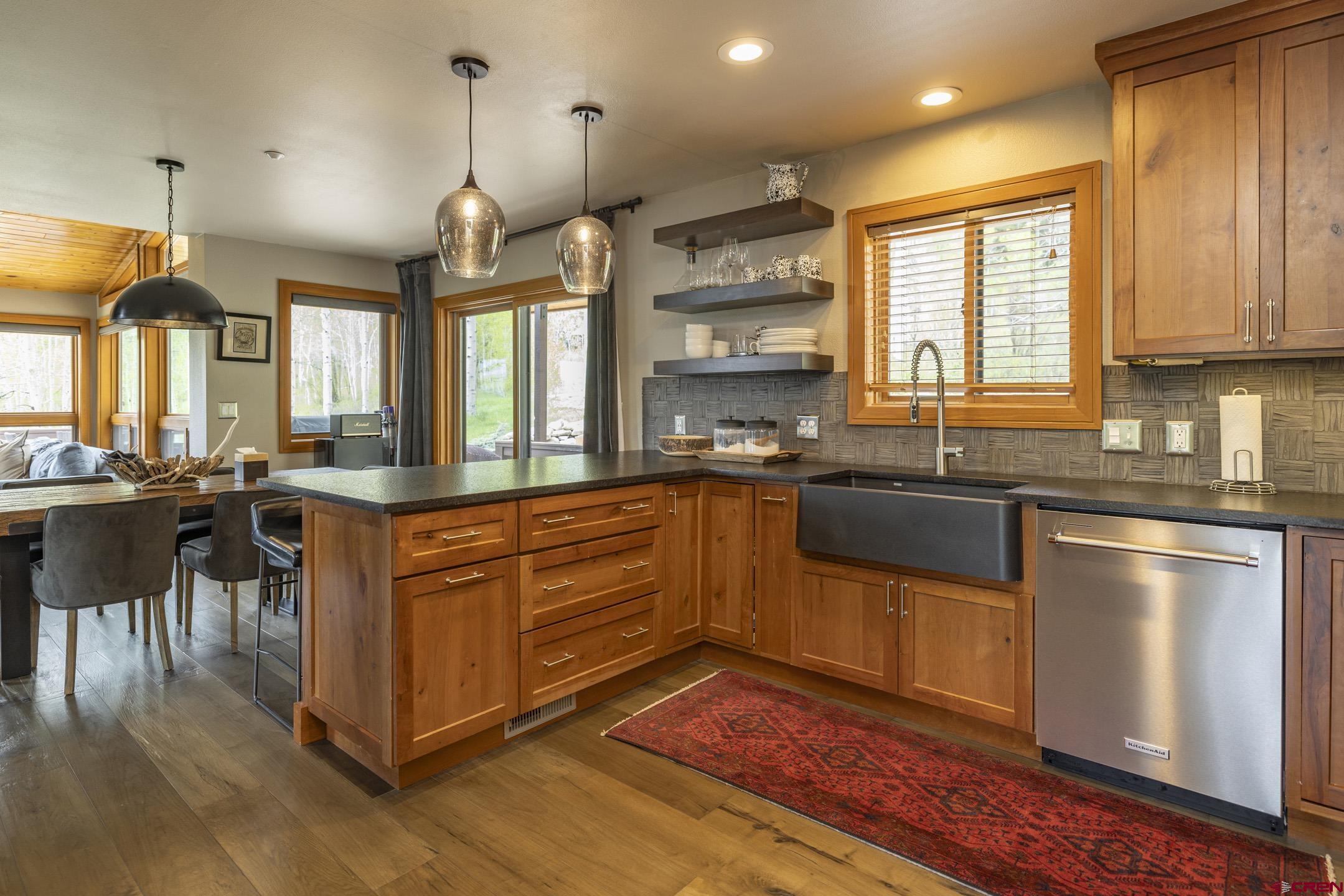 154 Falcon Ridge Road Durango, CO 81301 - Photo 18 of 42 a kitchen with stainless steel appliances granite countertop wooden floors and granite counter tops