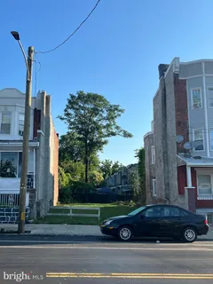 a view of a tall building next to a yard