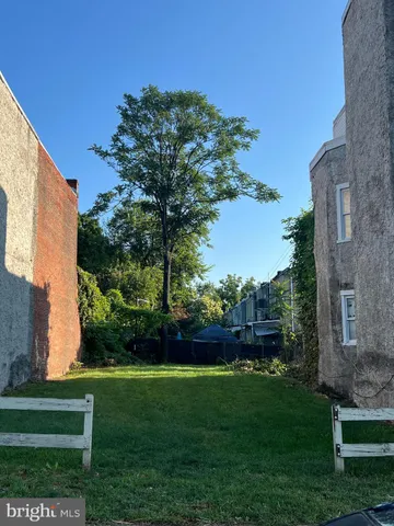 a view of a chair and table in the garden