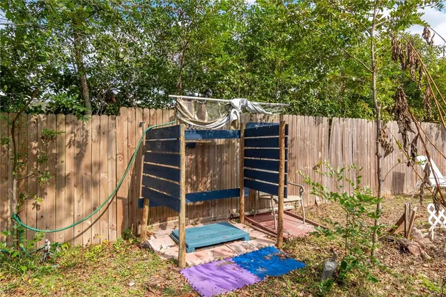 a wooden bench sitting in front of a building
