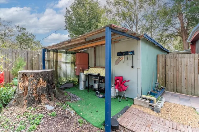 a view of backyard with patio and outdoor seating