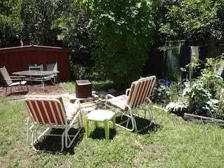 a view of a yard with table and chairs