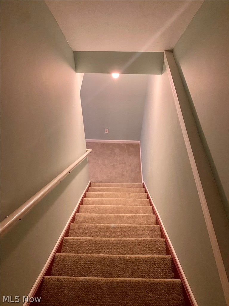 7790 Neff Road Medina, OH 44256 - Photo 23 of 29 Finished Basement - Walls are light blue and the carpet is gray.