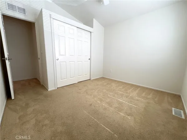 an empty room with a empty space and windows