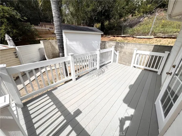 a view of balcony with wooden floor and seating space