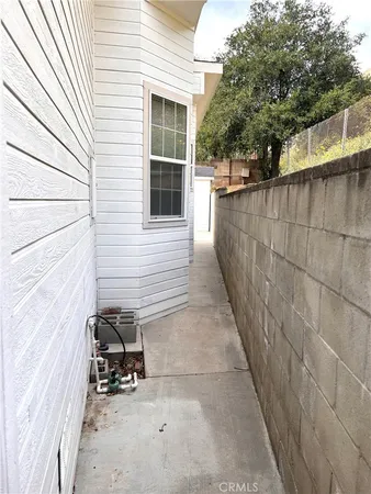 a view of a storage house with wooden fence