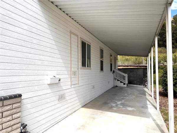 a view of a porch with a table and chairs and wooden floor