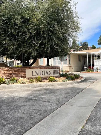 a view of a water fountain and trees