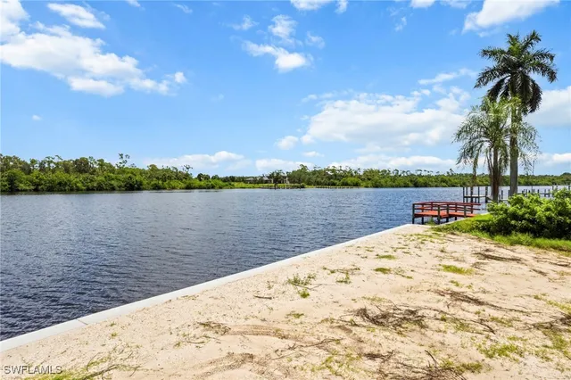 a view of swimming pool with a lake view and mountain in the back