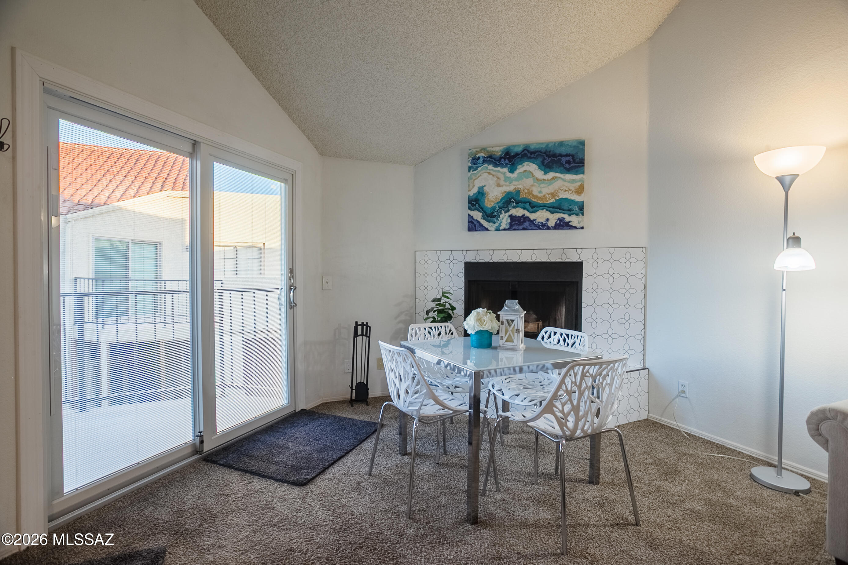 1200 East River Road, Unit B27 Tucson, AZ 85718 - Photo 12 of 40 a living room with furniture and a fireplace