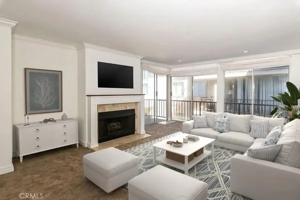 a living room with furniture a flat screen tv and a fireplace