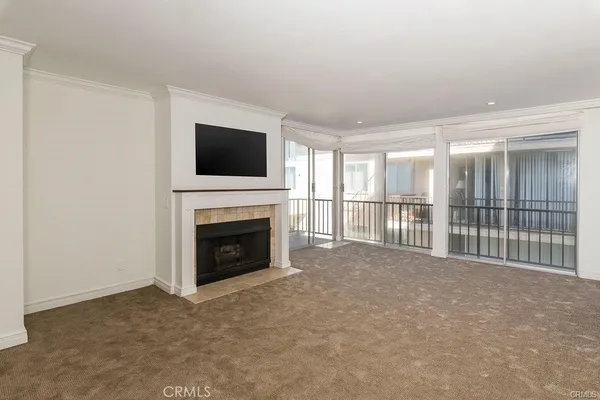 a view of a livingroom with an empty space and a fireplace