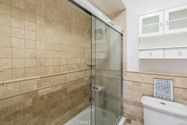 a bathroom with a toilet and a shower