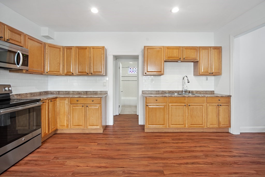 40 Orchard Street Chicopee, MA 01013 - Photo 14 of 34 a kitchen with stainless steel appliances granite countertop a sink and cabinets