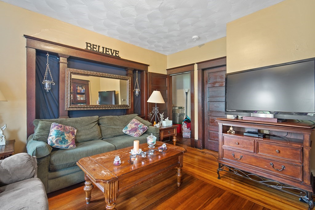 40 Orchard Street Chicopee, MA 01013 - Photo 30 of 34 a living room with furniture and a flat screen tv