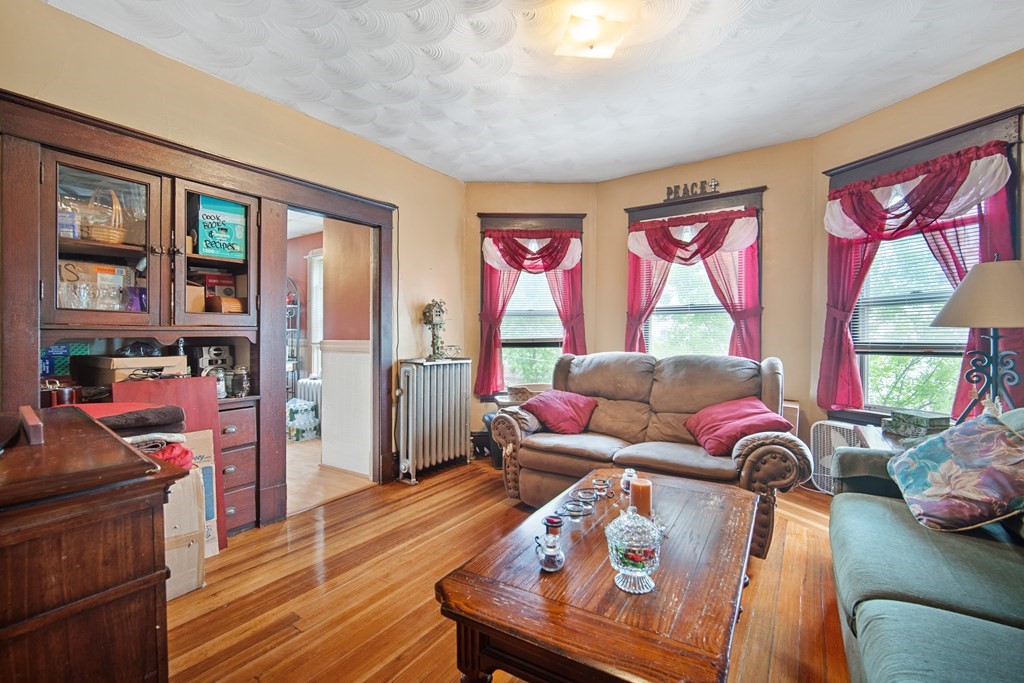 40 Orchard Street Chicopee, MA 01013 - Photo 32 of 34 a living room filled with furniture and a floor to ceiling window