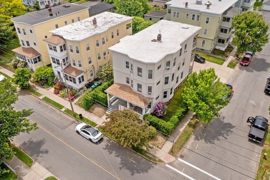 40 Orchard Street Chicopee, MA 01013 - Photo 7 of 34 an aerial view of a multi story residential apartment building with yard and parking spaces