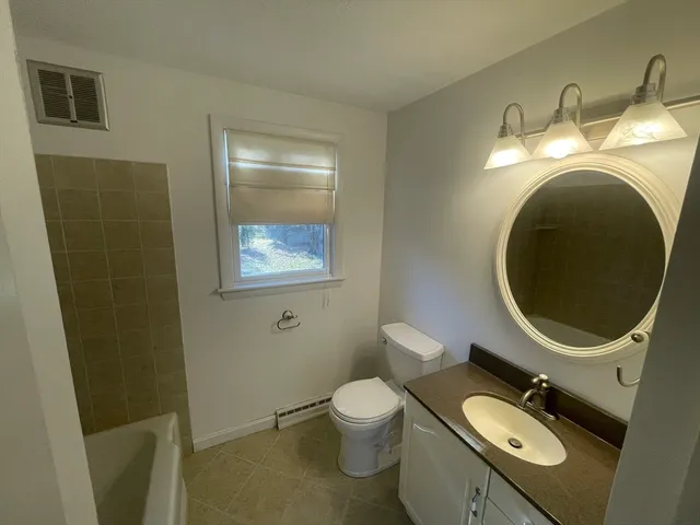 a view of a room with wooden floor and white walls