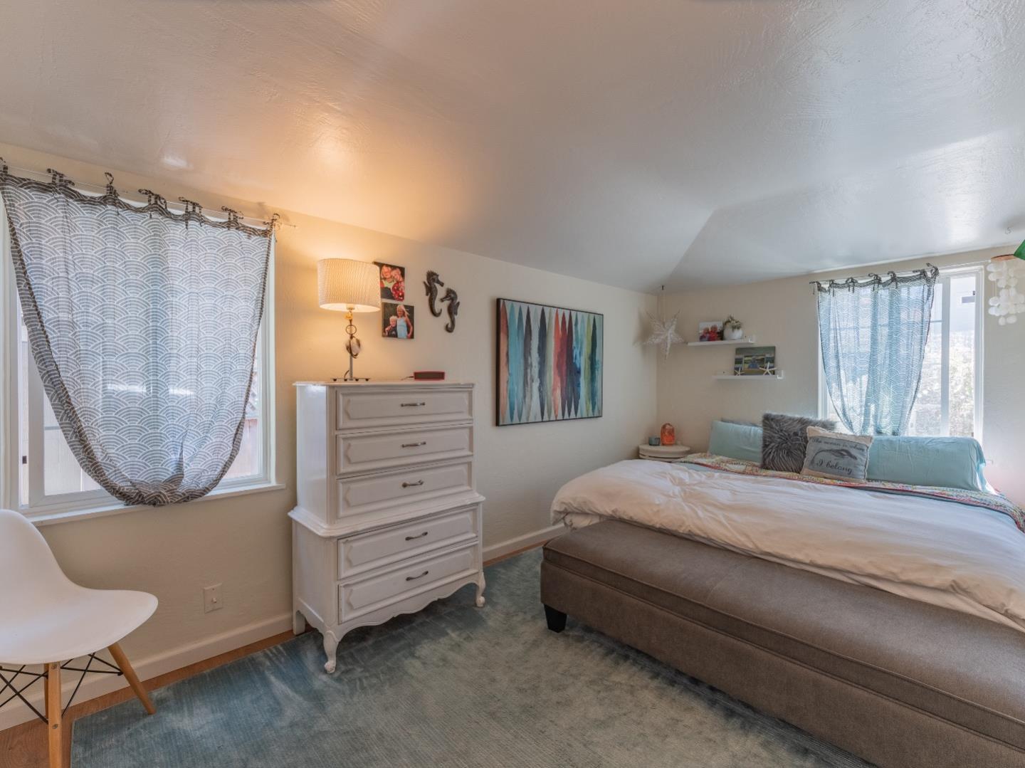 146 Hainline Road Aptos, CA 95003 - Photo 12 of 45 a bedroom with a bed a dresser and a mirror