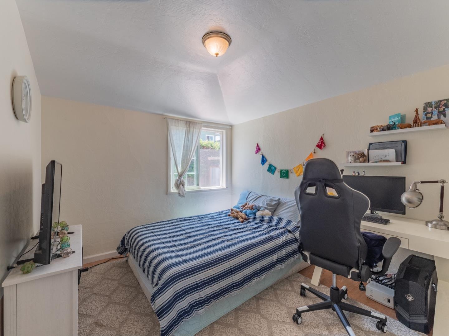 146 Hainline Road Aptos, CA 95003 - Photo 16 of 45 a bedroom with a bed and a desk