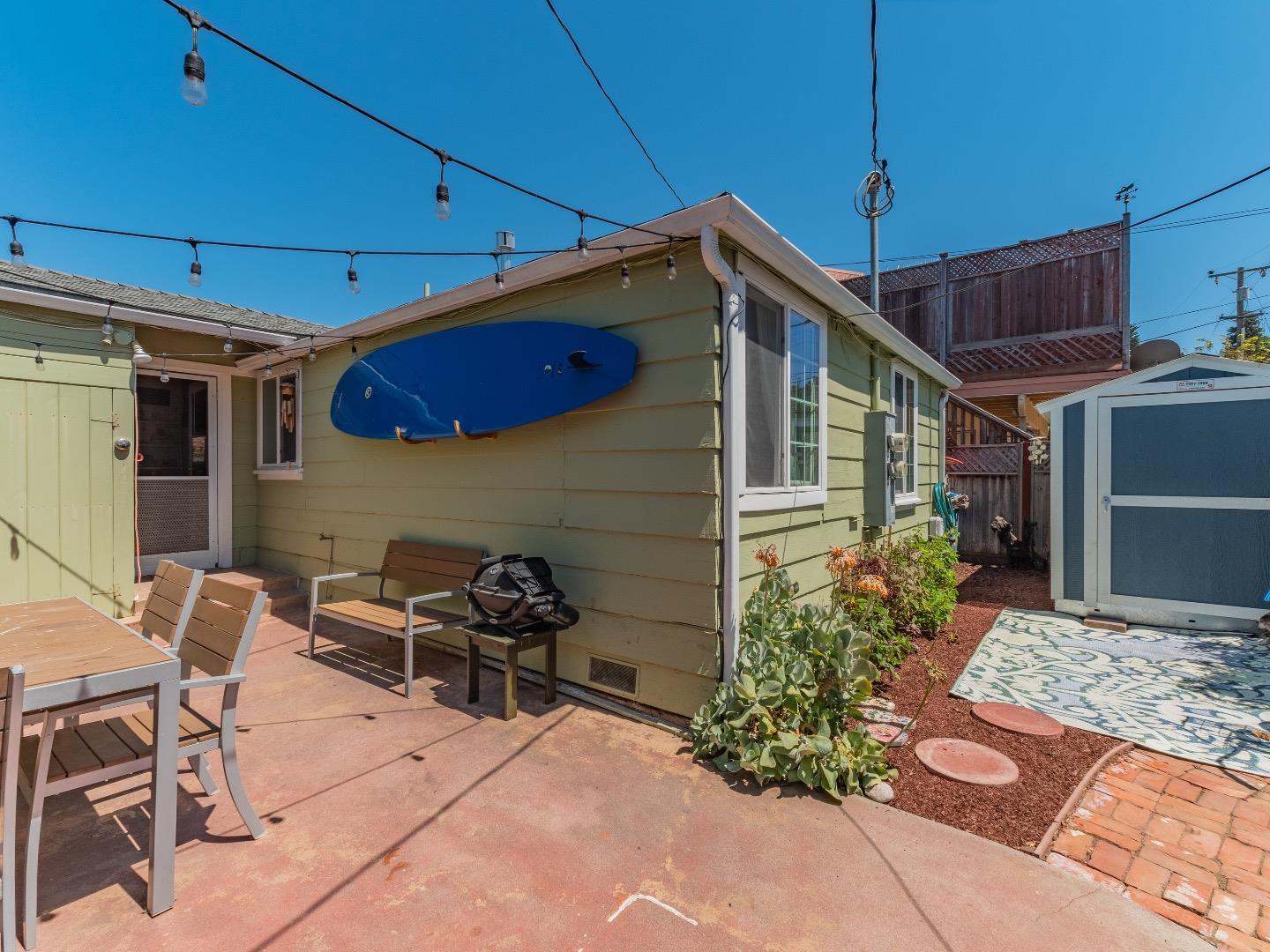 146 Hainline Road Aptos, CA 95003 - Photo 19 of 45 a patio with table and chairs and potted plants
