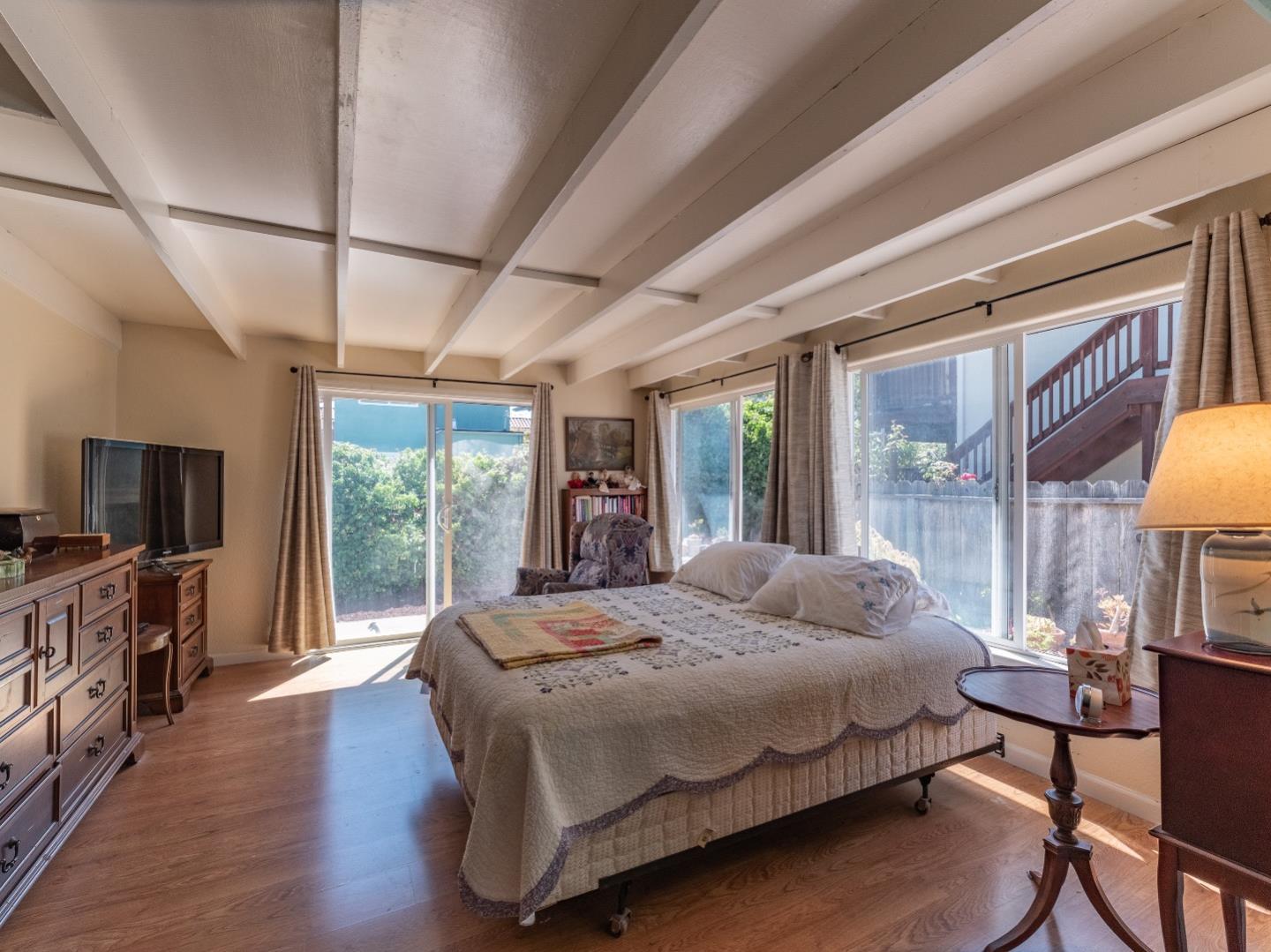 146 Hainline Road Aptos, CA 95003 - Photo 25 of 45 a bedroom with a large bed and a flat tv screen on dresser