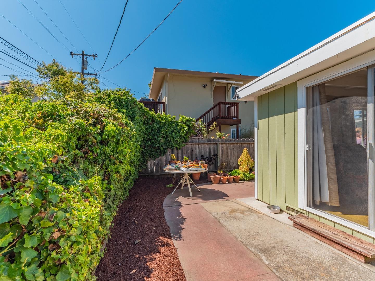 146 Hainline Road Aptos, CA 95003 - Photo 29 of 45 a view of a patio with table and chairs and potted plants
